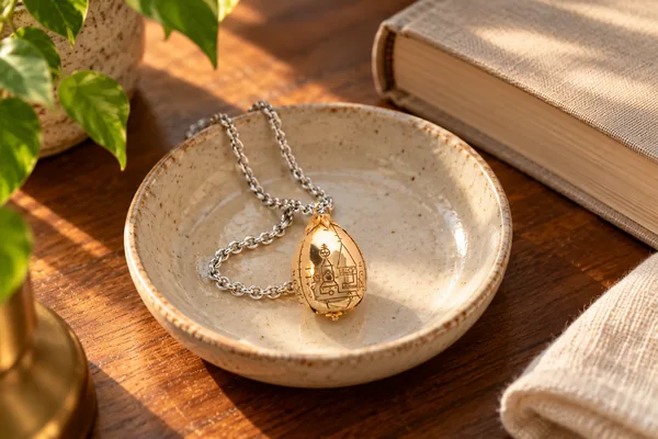 AI styling illustration of The Golden Egg pendant in a bedside jewellery dish