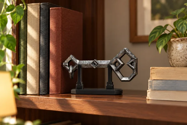 AI styling illustration of the weathered Key to Erebor replica on its small black stand among books